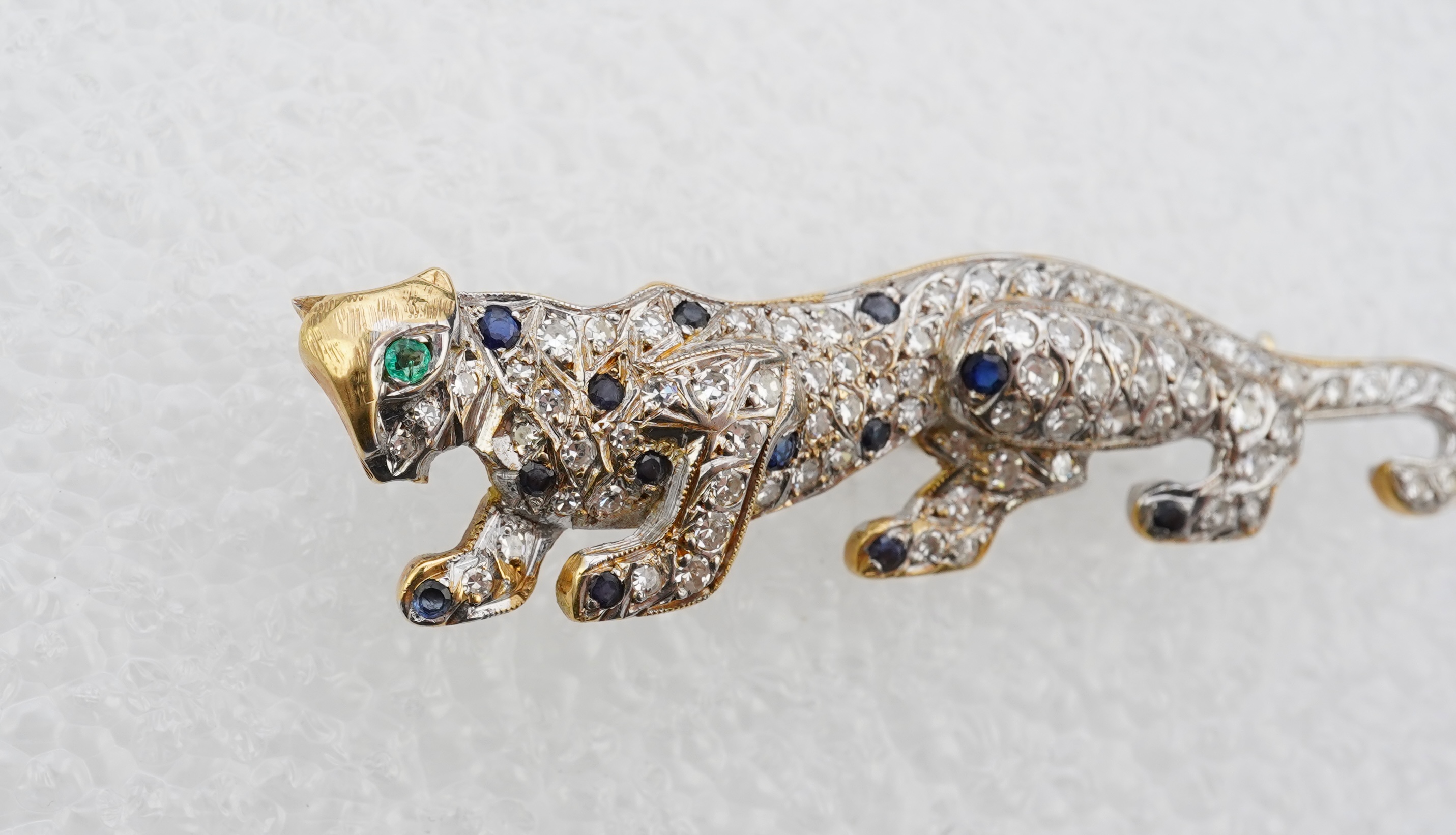 A sapphire, emerald and diamond brooch, circa 1988